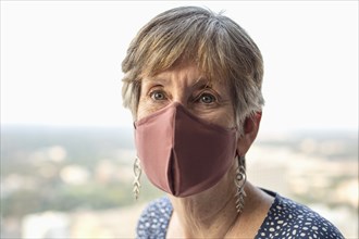 Senior woman wearing protective face mask