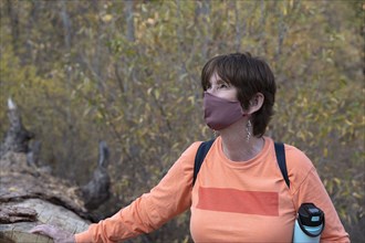 Hiker with face mask in Bandelier National Monument
