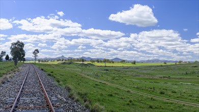Railroad track under blue sky