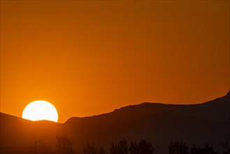 Sun rising behind mountain
