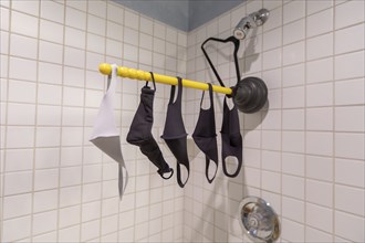 Fabric protective masks against coronavirus drying in home shower