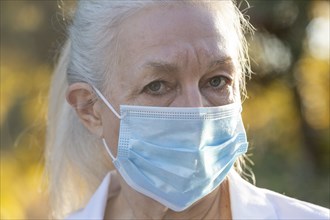 Portrait of senior female medical staff in covid protective mask