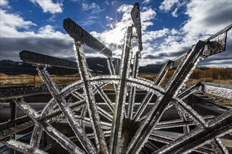 Frosted water wheel on ranch in morning sun