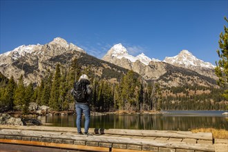 Senior woman standing by Taggart Lake in Grand Teton National Park