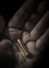 Close-up of hand holding bullet