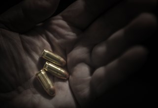 Close-up of hand holding bullets