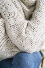 Close-up of woman in white woolen sweater