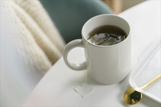 Mug with tea on table