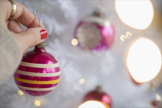 Hand decorating Christmas tree