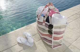 Sandals and bag at poolside