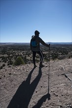 Female hiker looking at Galisteo Basin Preserve