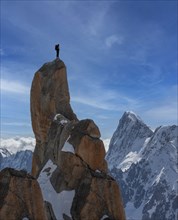 Chamonix, Climber standing on top of Aiguille du Midi in Mont Blanc Massif