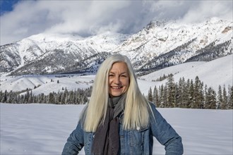 Winter portrait of senior woman in front of Boulder Mountains