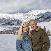 Winter portrait of senior couple in front of Boulder Mountains