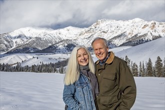 Winter portrait of senior couple in front of Boulder Mountains