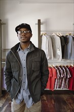 African American man standing in clothing store