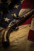 Flintlock pistol with American flag and Declaration of Independence
