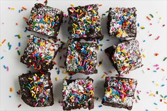 Overhead view of freshly baked brownies covered with colorful sprinkles