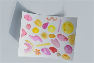 Studio shot of paper with colorful painted pattern
