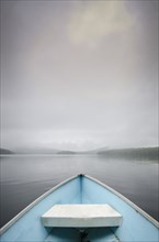 View from rowboat on foggy lake