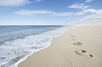 Footprints on empty beach