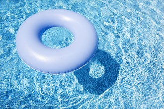 Blue inflatable ring floating on pool water surface