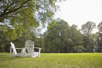 Pair of Adirondack chairs in back yard