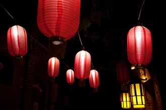 Paper lanterns on city street at night