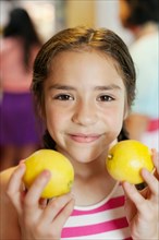 Girl holding two lemons
