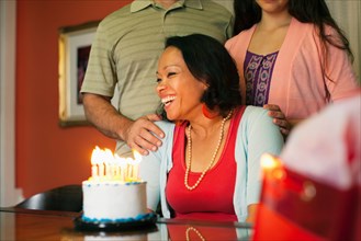 Woman smiling over birthday cake