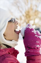 Girl licking snow