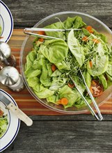 Overhead view of a bowl of salad on table