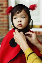 Girl wearing ladybird costume