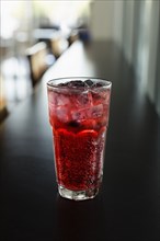 Mixed berry sparkling tea on coffee shop counter