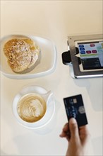 Customer paying for coffee in coffee shop