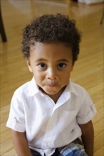 High angle portrait of preschool boy looking at camera smiling