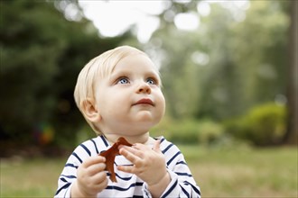Portrait of baby girl sitting on outdoors