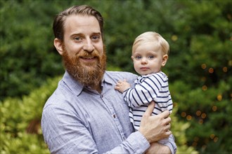 Portrait of father holding baby girl