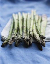 Still life of fresh raw asparagus on napkin