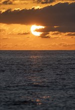Sun rising over sea