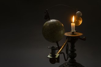 Antique globe and candle solar system model
