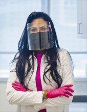 Portrait of female doctor wearing face mask and face shield