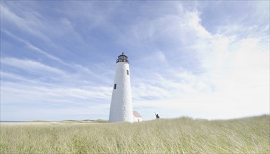 Woman waving by Great Point Light