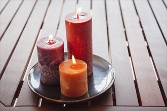 Candles and stones on wooden table