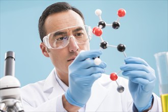 Scientist holding molecule model