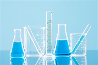 Laboratory glassware against blue background