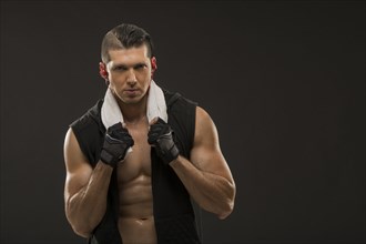 Portrait of muscular man wearing sports gloves