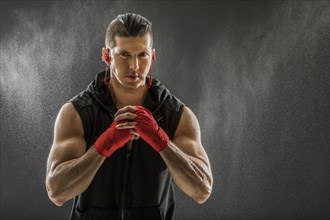 Portrait of muscular man in boxing gloves