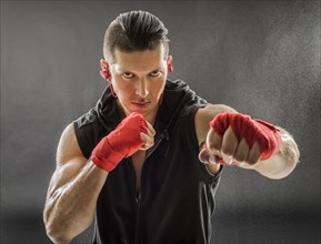 Portrait of muscular man in boxing stance