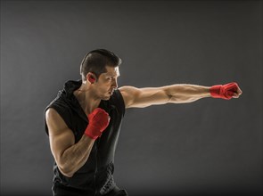 Muscular man training boxing